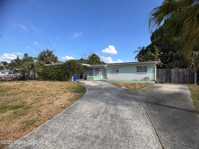 a view of a house with a yard and a garage