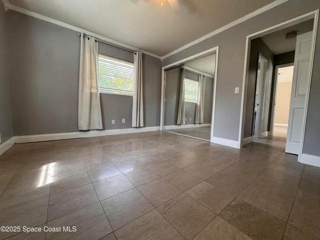 a view of a livingroom with an empty space and a window