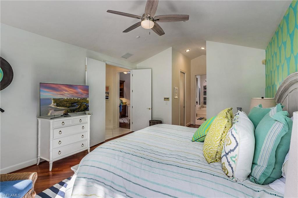 720 Turkey Oak Lane Naples, FL 34108 - Photo 16 of 31 a bedroom with a bed dresser and a window