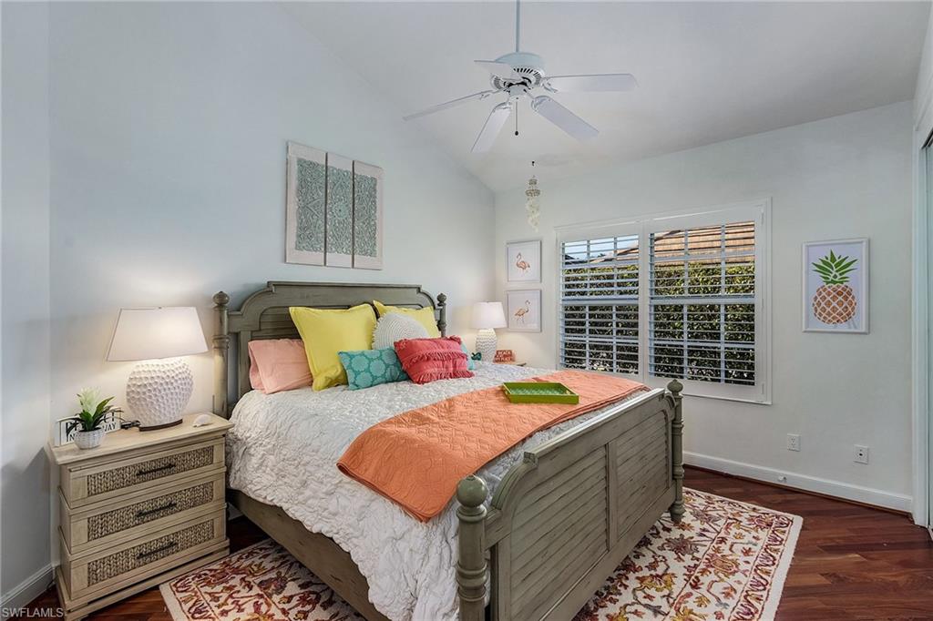 720 Turkey Oak Lane Naples, FL 34108 - Photo 21 of 31 a bedroom with bed and window