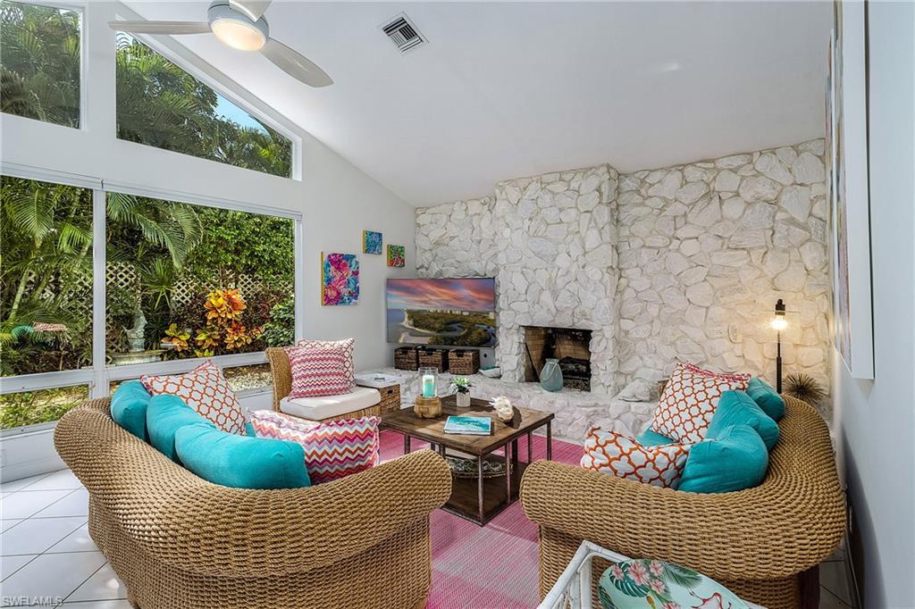 720 Turkey Oak Lane Naples, FL 34108 - Photo 26 of 31 a living room with furniture and a fireplace