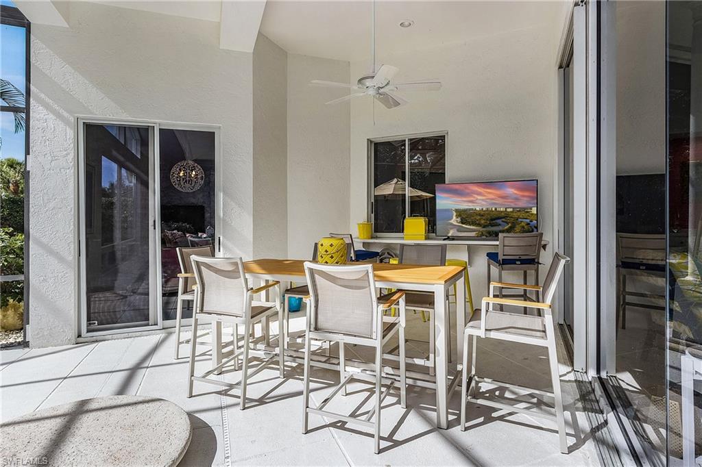720 Turkey Oak Lane Naples, FL 34108 - Photo 28 of 31 a dining room with furniture and window