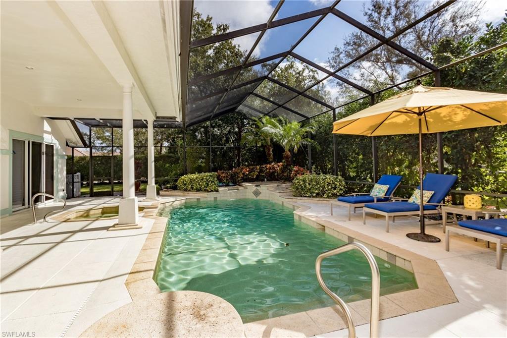720 Turkey Oak Lane Naples, FL 34108 - Photo 29 of 31 a view of a swimming pool with a patio