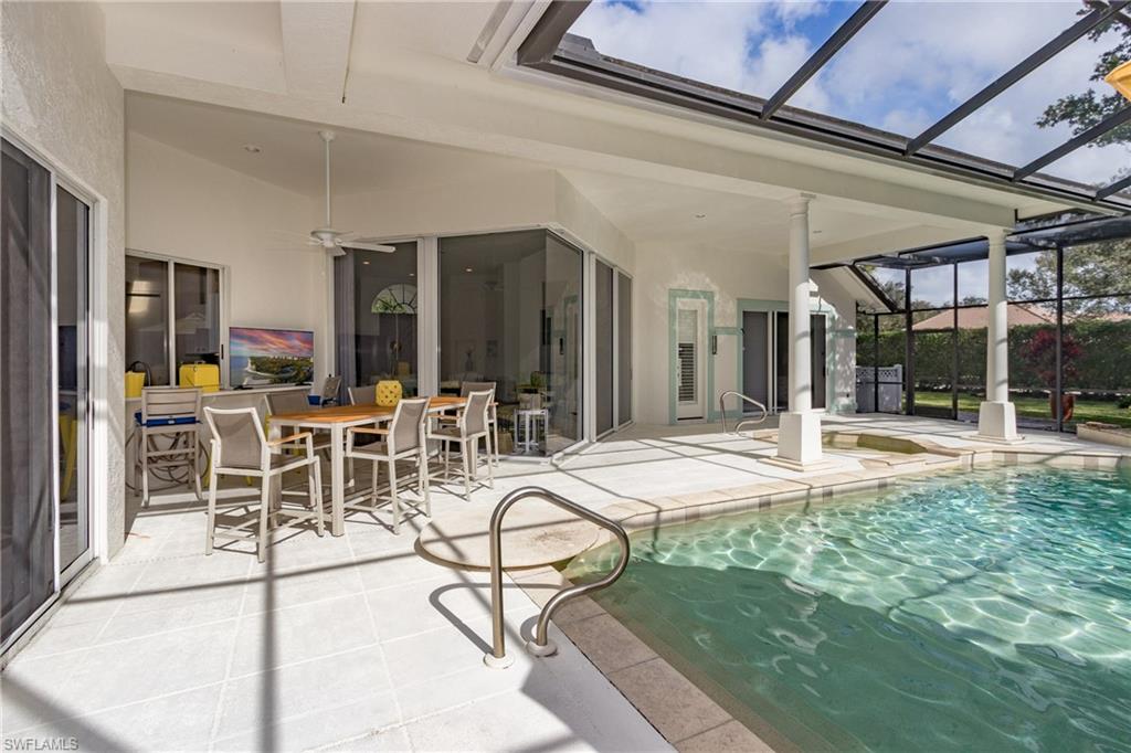 720 Turkey Oak Lane Naples, FL 34108 - Photo 30 of 31 a room with lots of chairs and mirrors