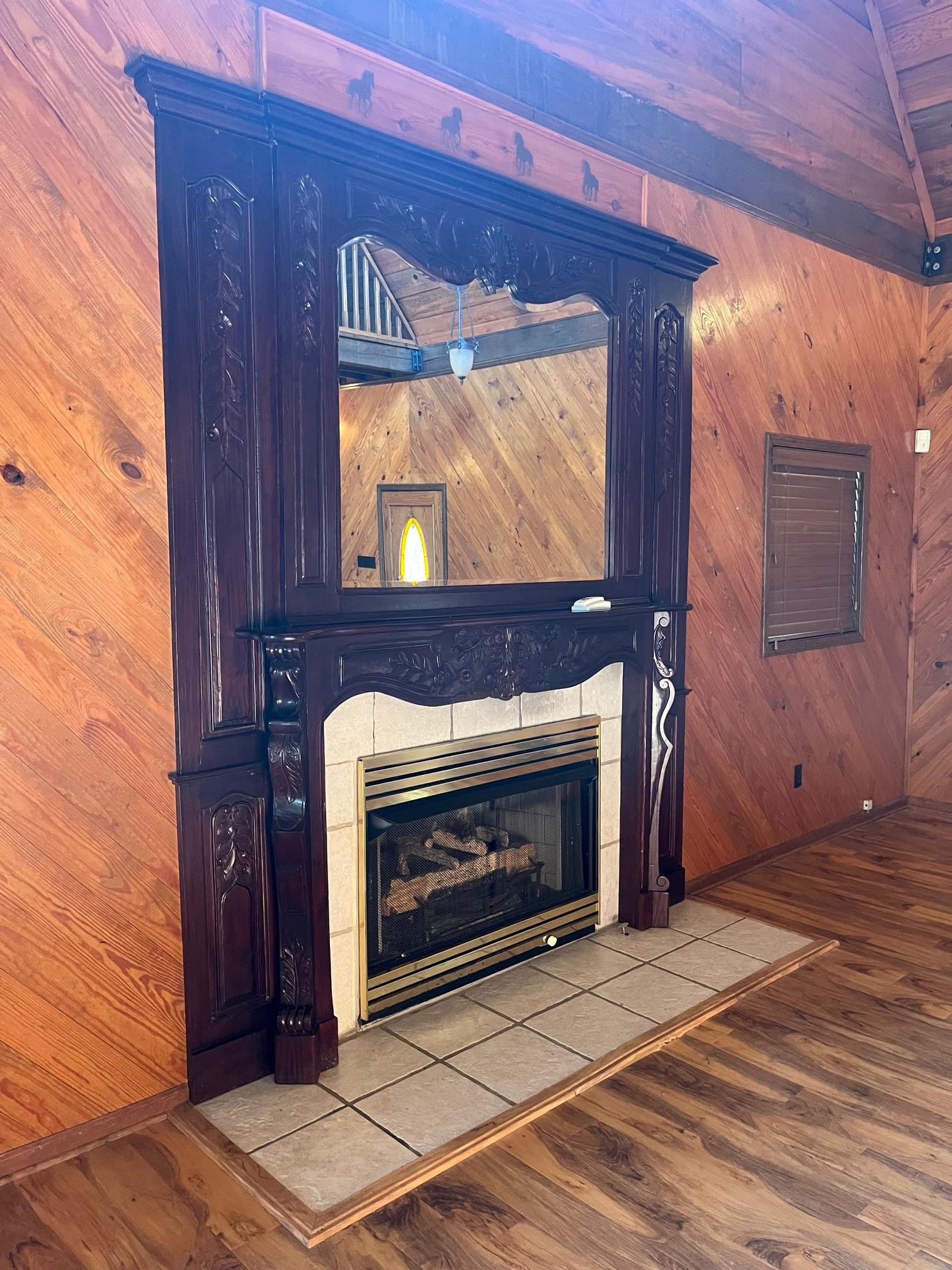 4161 Lucy Road Millington, TN 38053 - Photo 14 of 24 Detailed view of a tiled fireplace, wood finished floors, and wooden walls
