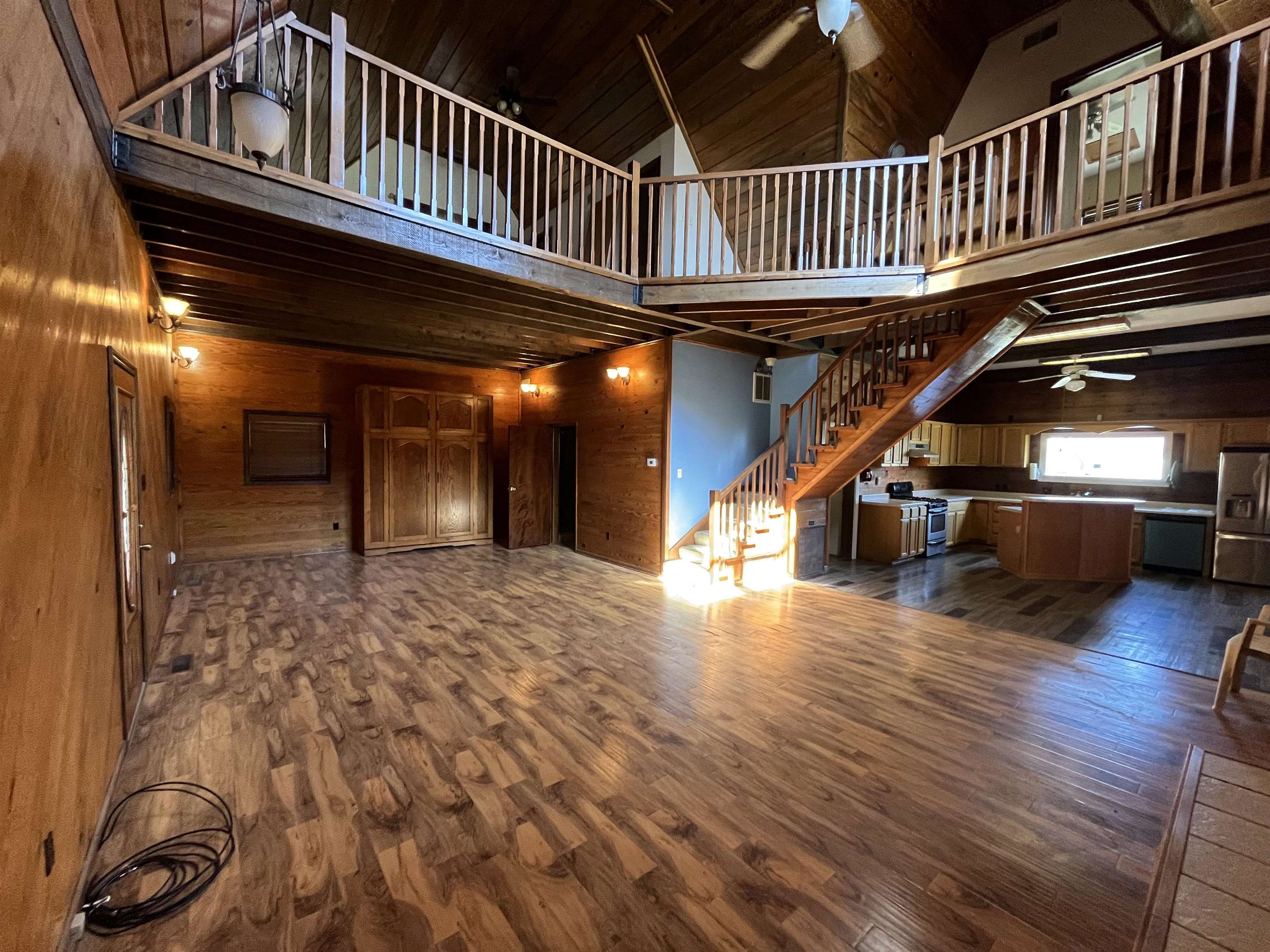 4161 Lucy Road Millington, TN 38053 - Photo 18 of 24 Unfurnished living room featuring a ceiling fan, wood walls, dark wood-type flooring, and a vaulted wood ceiling
