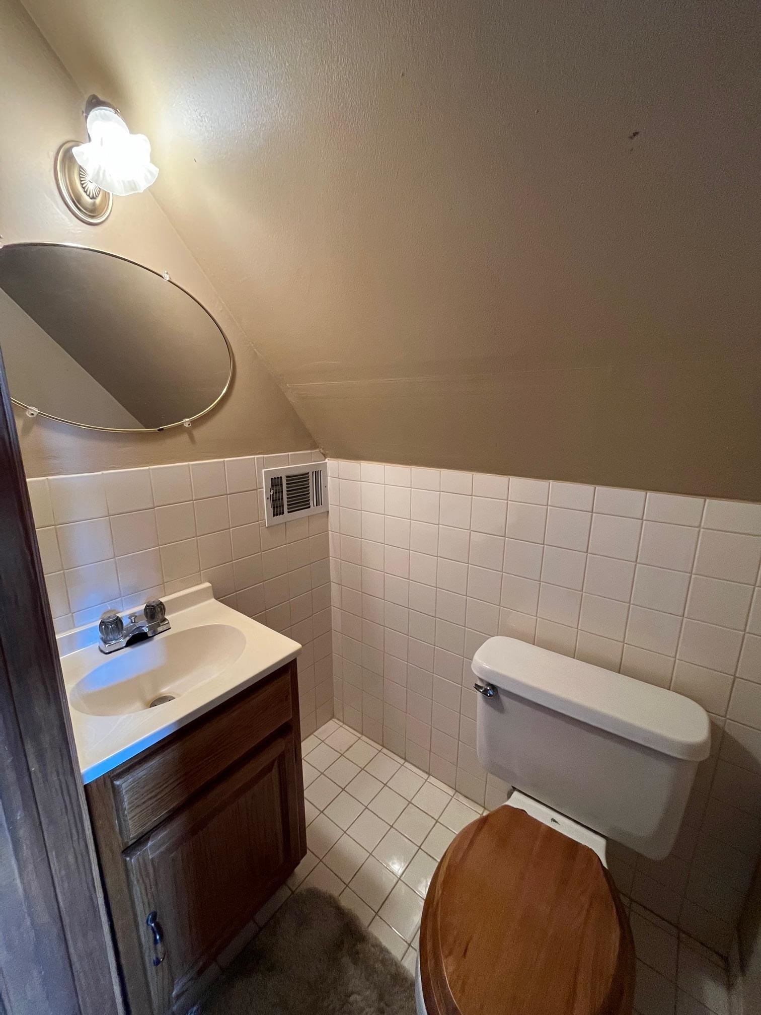 4161 Lucy Road Millington, TN 38053 - Photo 23 of 24 Half bath with tile walls, vanity, wainscoting, and light tile patterned floors