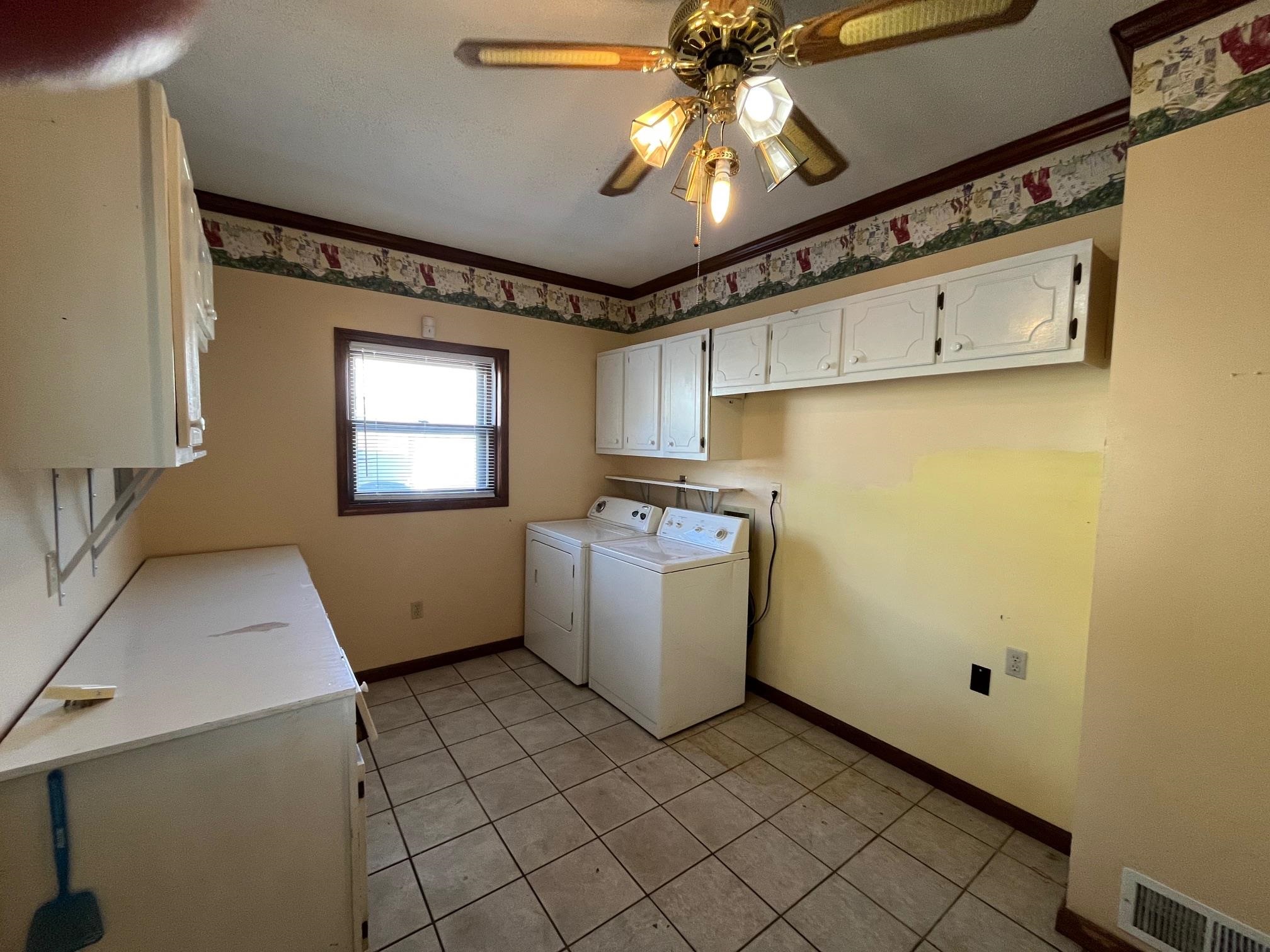 4161 Lucy Road Millington, TN 38053 - Photo 24 of 24 Laundry area with cabinet space, ceiling fan, independent washer and dryer, crown molding, and light tile patterned floors