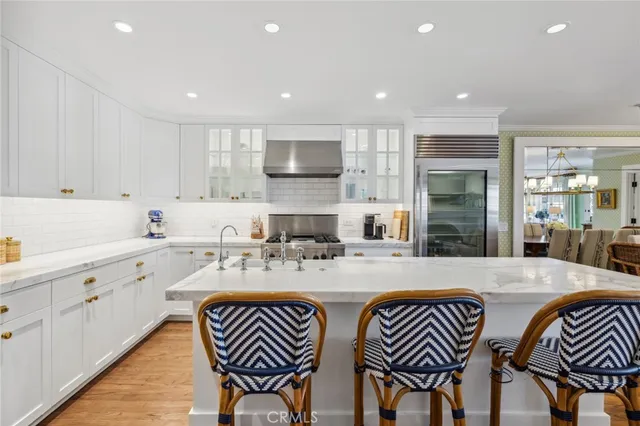 a large kitchen with stainless steel appliances granite countertop a sink and cabinets