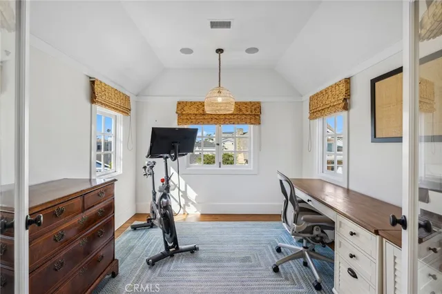 a view of a workspace with furniture and a window