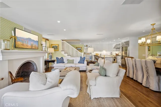 a living room with furniture fireplace and wooden floor
