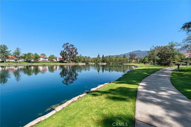 a view of a lake with houses in the back