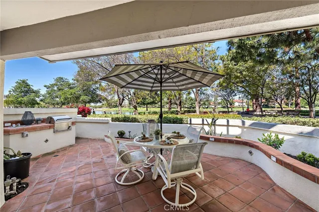 a view of a patio with a table chairs and backyard