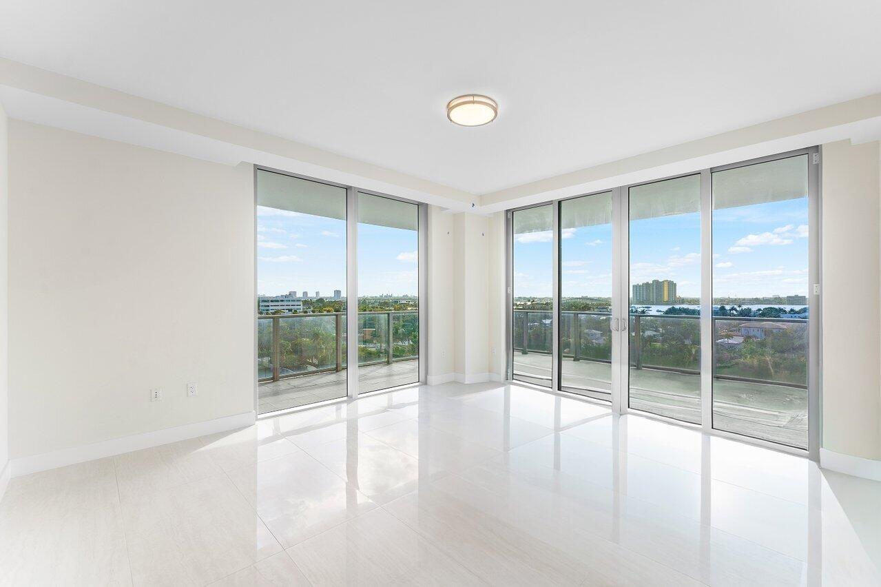 3100 North Ocean Drive, Unit P705 Riviera Beach, FL 33404 - Photo 14 of 98 a view of an empty room with wooden floor and windows