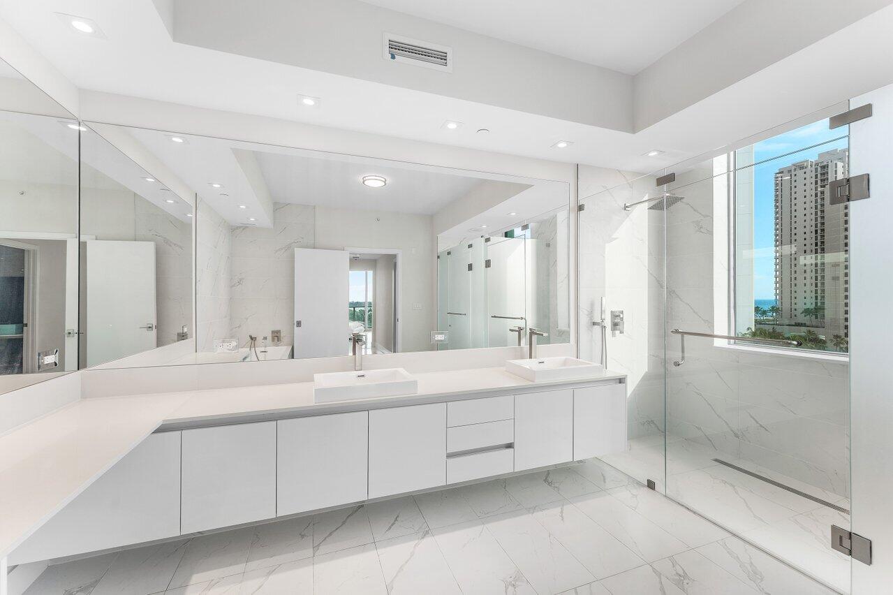 3100 North Ocean Drive, Unit P705 Riviera Beach, FL 33404 - Photo 16 of 98 a large bathroom with a double vanity sink mirror and double