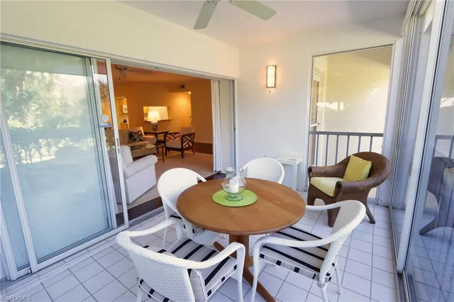 a dining room with furniture and a window