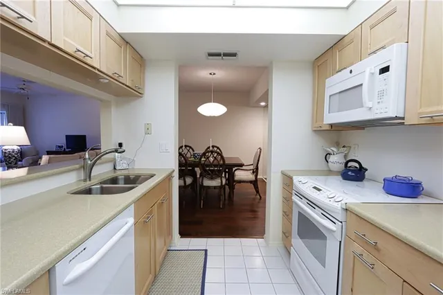 a kitchen with a sink cabinets and window