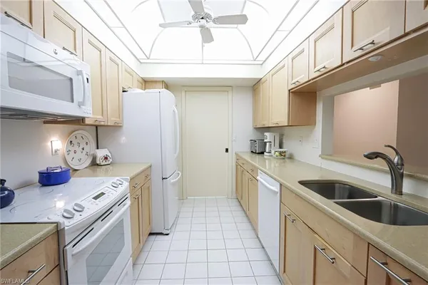 a kitchen with stainless steel appliances granite countertop a sink and cabinets
