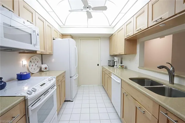 a kitchen with stainless steel appliances granite countertop a sink and cabinets