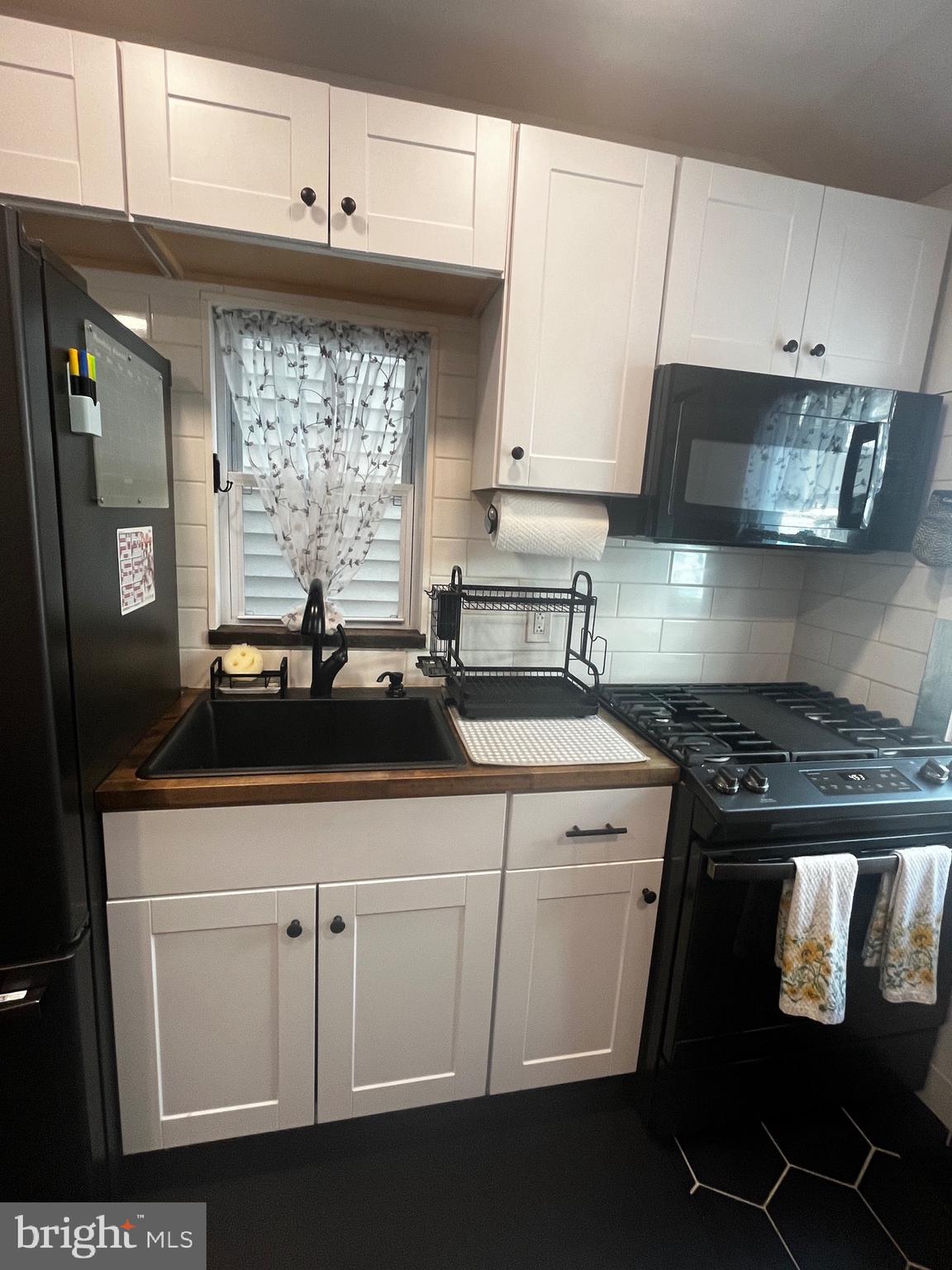 121 Mercy Street Philadelphia, PA 19148 - Photo 21 of 61 a kitchen with a sink and cabinets