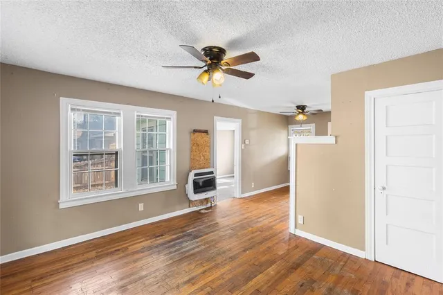 a view of a livingroom with a ceiling fan and carpet