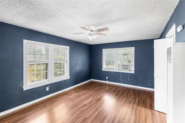 a view of an empty room with wooden floor