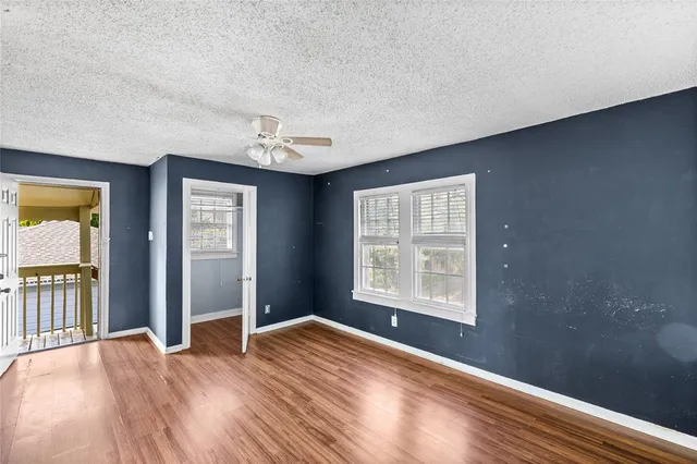 a view of a room with a chandelier fan and bathroom