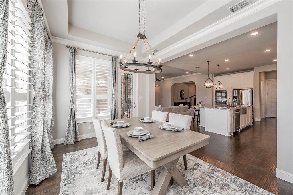 11609 Little Elm Creek Road Flower Mound, TX 76226 - Photo 13 of 40 a view of a dining room and livingroom with furniture wooden floor a chandelier