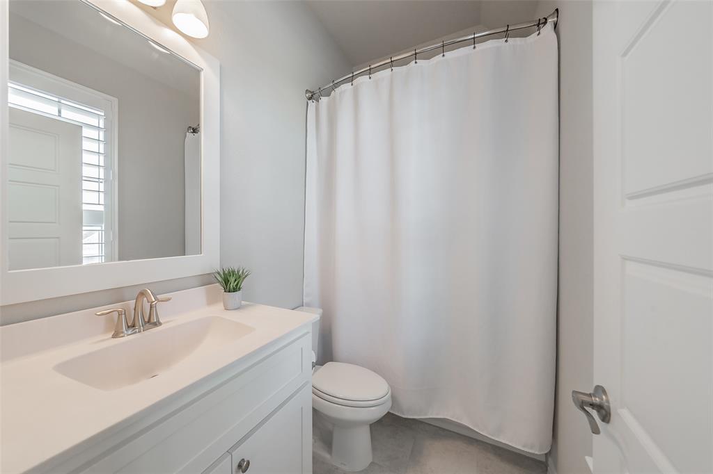 11609 Little Elm Creek Road Flower Mound, TX 76226 - Photo 23 of 40 a bathroom with a granite countertop sink toilet and a mirror