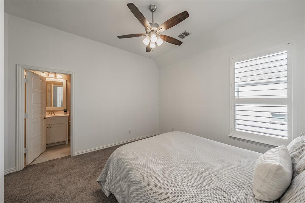 11609 Little Elm Creek Road Flower Mound, TX 76226 - Photo 24 of 40 a bedroom with a bed and a ceiling fan