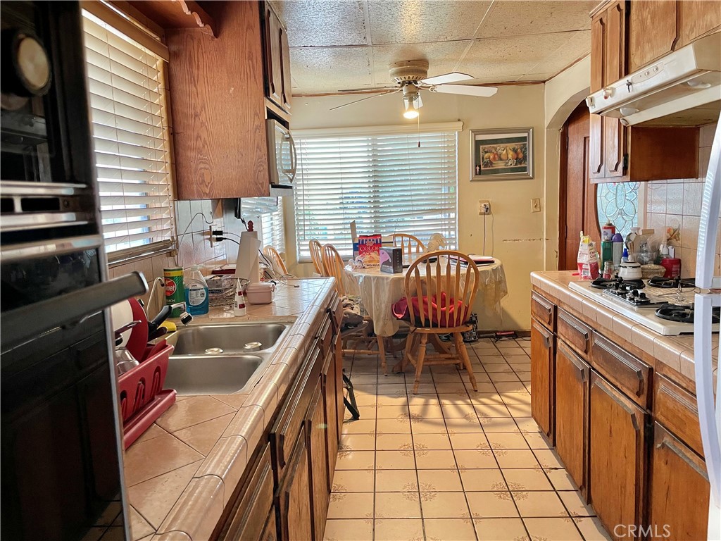 2525 Falling Leaf Avenue Rosemead, CA 91770 - Photo 16 of 28 a kitchen with stainless steel appliances granite countertop sink stove and cabinets