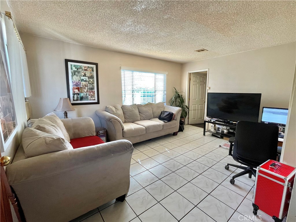 2525 Falling Leaf Avenue Rosemead, CA 91770 - Photo 8 of 28 a living room with furniture and a flat screen tv