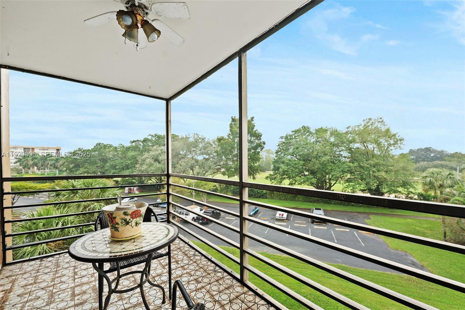 a view of a balcony with chair and a floor to ceiling window
