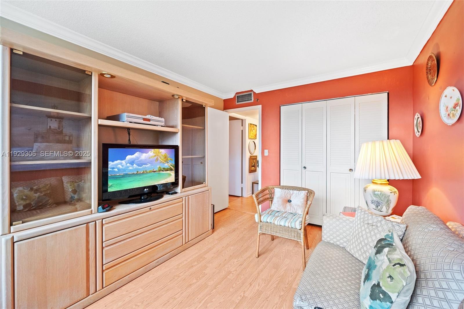 900 St Charles Place, Unit 419 Pembroke Pines, FL 33026 - Photo 24 of 27 a living room with furniture and a flat screen tv