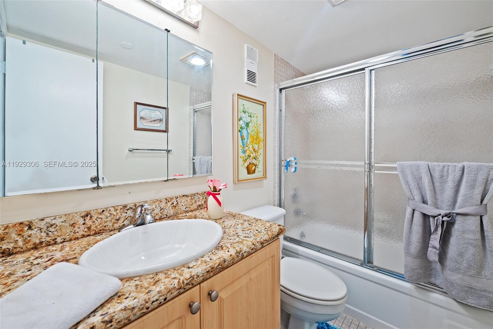 900 St Charles Place, Unit 419 Pembroke Pines, FL 33026 - Photo 25 of 27 a bathroom with a granite countertop sink toilet and shower