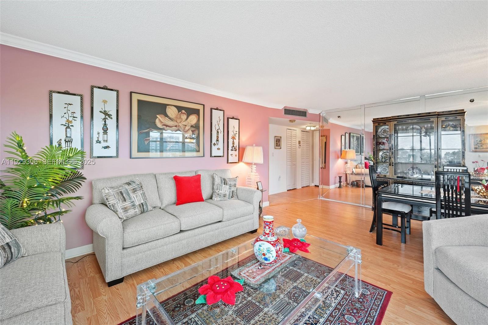 900 St Charles Place, Unit 419 Pembroke Pines, FL 33026 - Photo 8 of 27 a living room with furniture and a potted plant