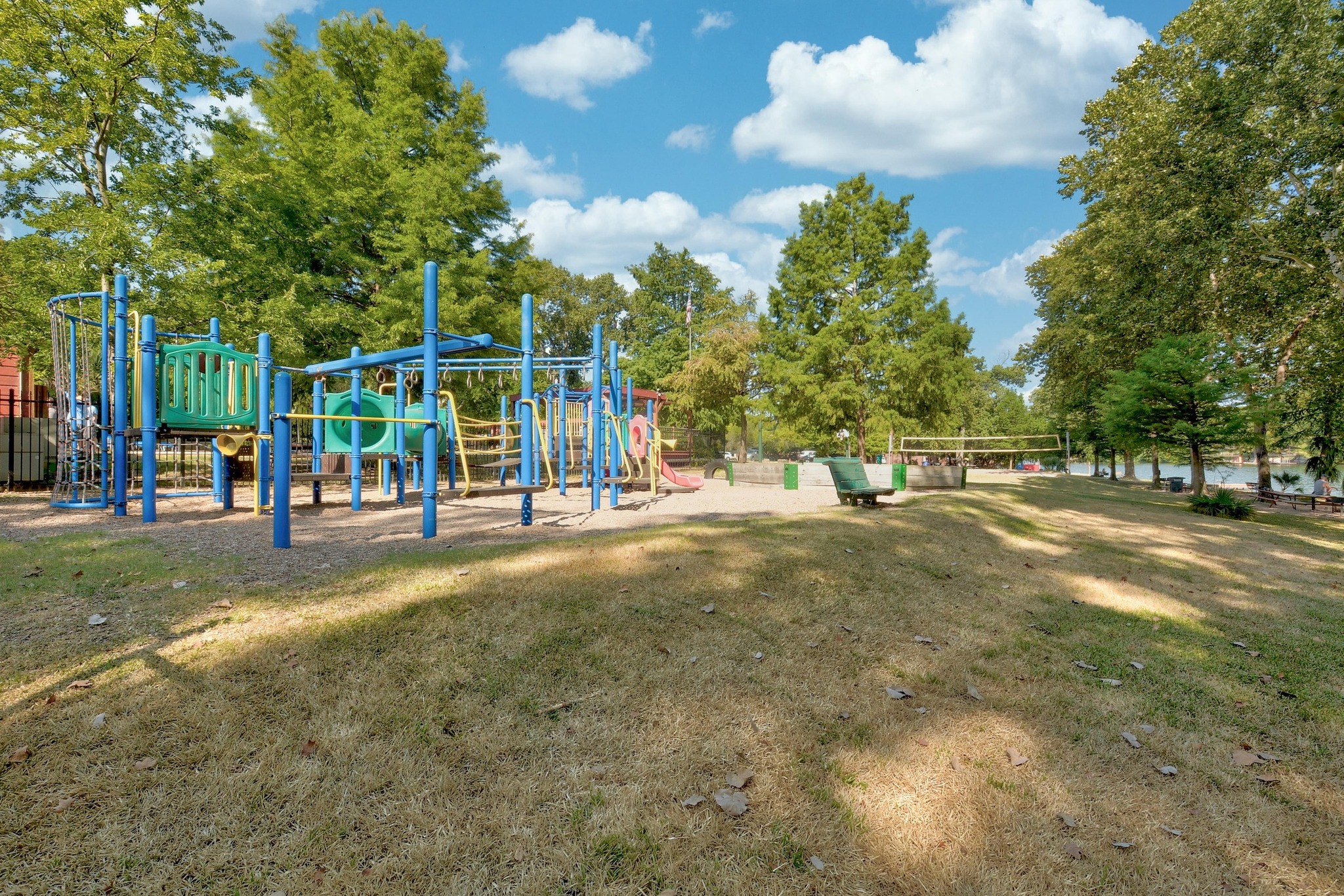 1107 Bowie Road Austin, TX 78733 - Photo 38 of 40 A vibrant playground and expansive grassy area for recreation with mature trees providing ample shade.