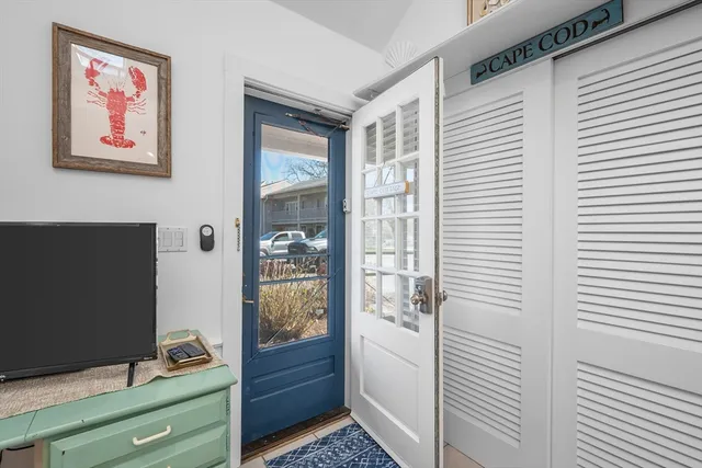 a living room with furniture a flat screen tv and a table