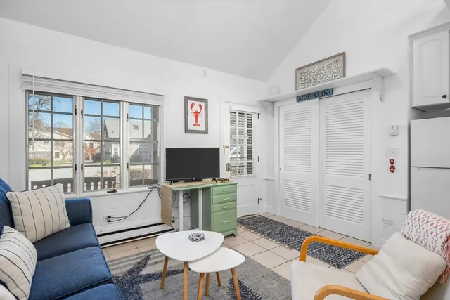 a living room with furniture and kitchen view