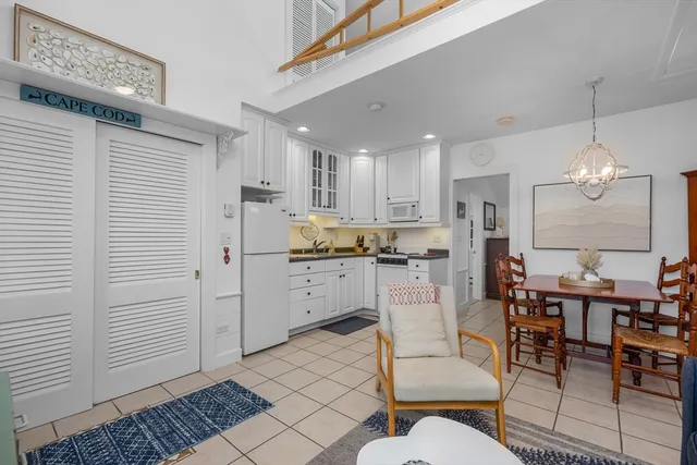 a living room with stainless steel appliances kitchen island granite countertop furniture and a kitchen view