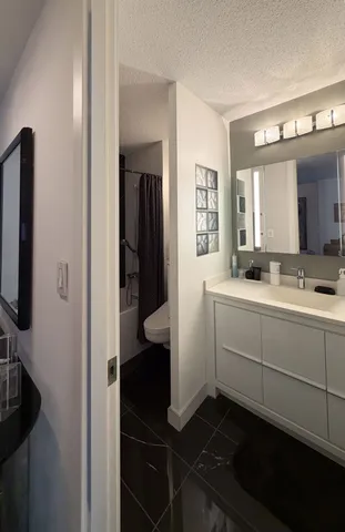 a bathroom with a sink toilet and shower