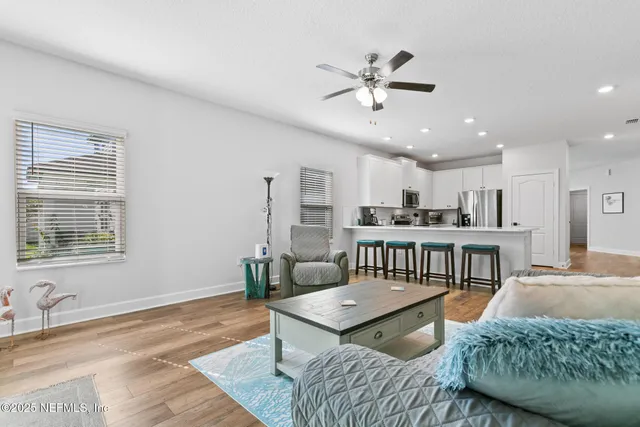a living room with furniture and kitchen view