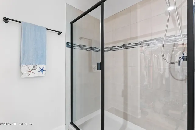 a bathroom with a shower and a sink