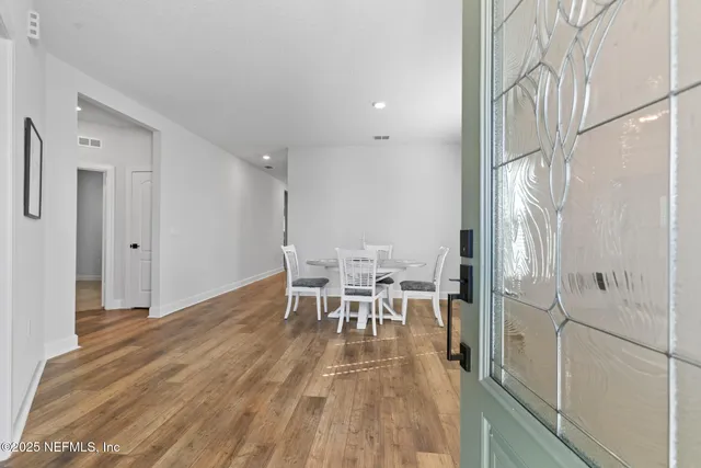 a dining room with furniture and wooden floor