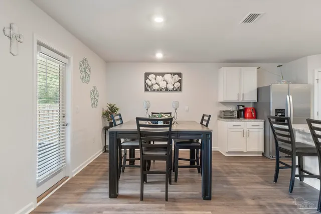 a view of kitchen with refrigerator dining table and chairs