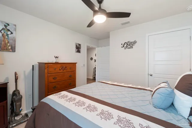 a bedroom with a bed and a dresser
