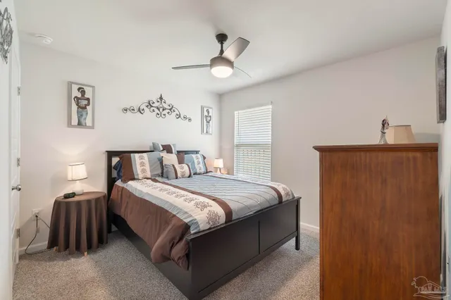 a bedroom with bed and a chandelier