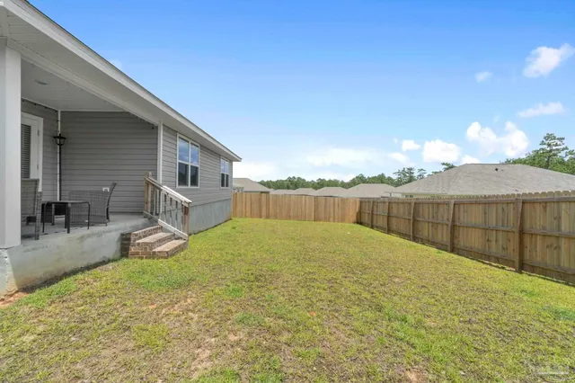 a house view with swimming pool in front of it