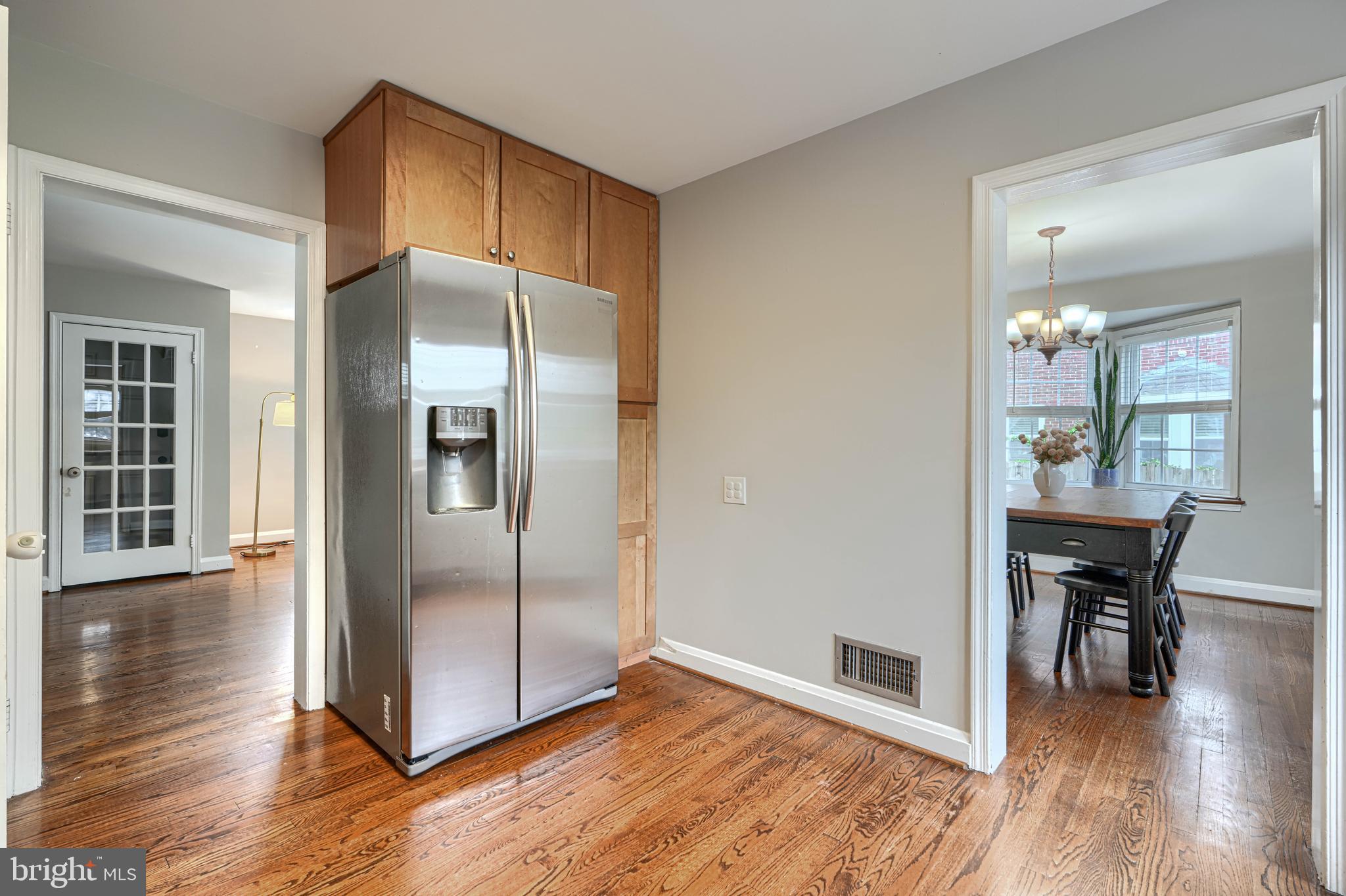 8132 Pleasant Plains Road Towson, MD 21286 - Photo 17 of 55 a kitchen with granite countertop a refrigerator and wooden floor