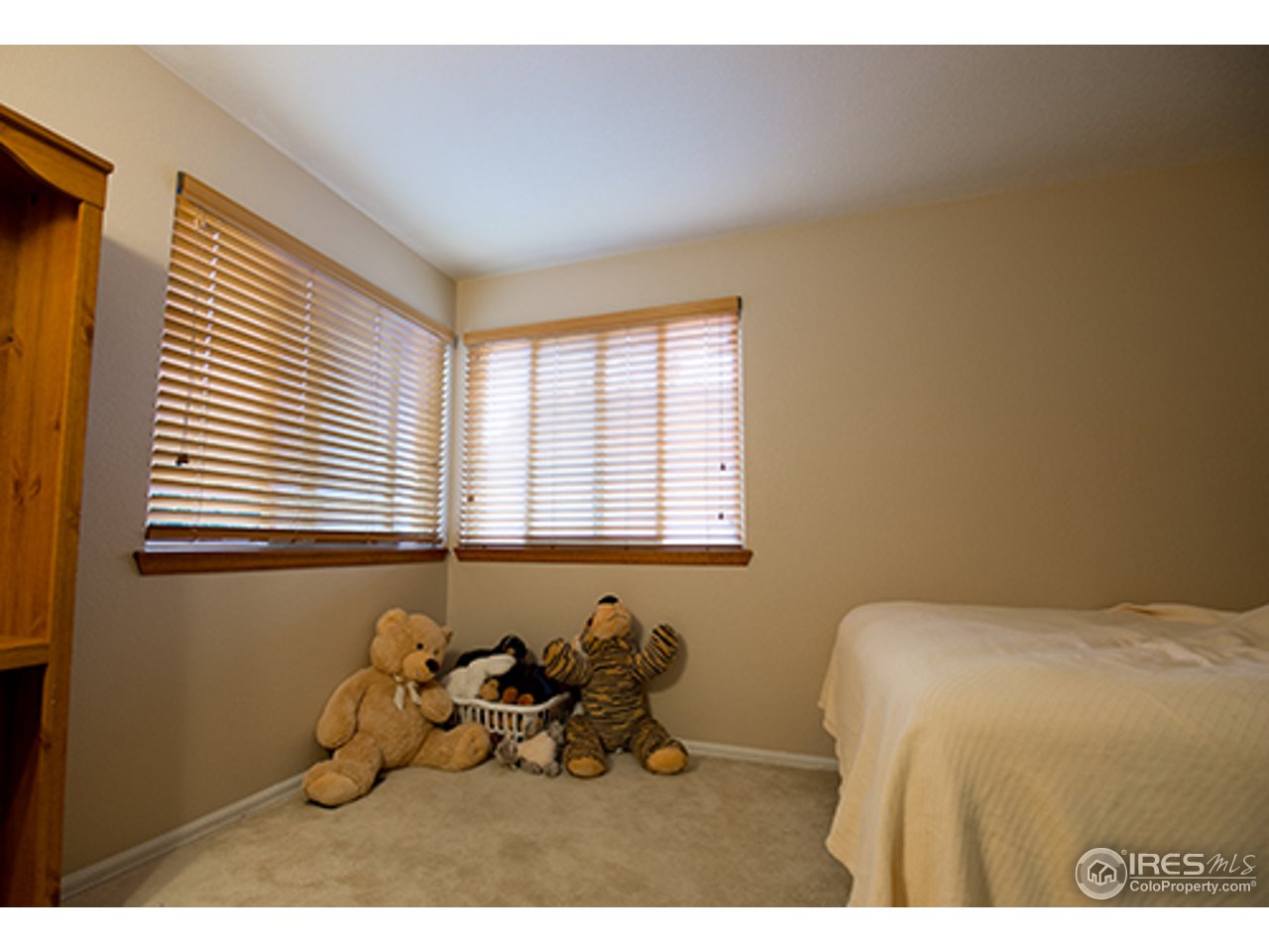 2445 Rim Drive Broomfield, CO 80020 - Photo 11 of 13 a bed room with a bed and a chair